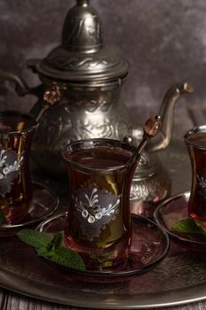 tray with glasses and serving pitcher of authentic Moorish tea ready to drink with mint leaves