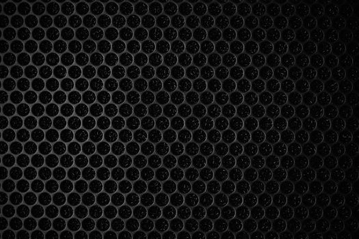 Safety net on the music speaker. Protective grid audio speakers. Close view of Black safety net. Metal perforated mesh, abstract pattern, Abstract black background. Professional audio equipment.
