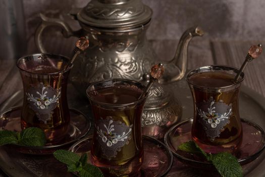 tray with glasses and serving pitcher of authentic Moorish tea ready to drink with mint leaves