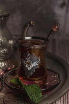 tray with glasses and serving pitcher of authentic Moorish tea ready to drink with mint leaves