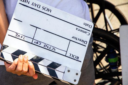 close up image of film production crew holding Film Slate on set