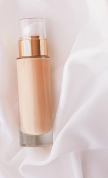 Cosmetic branding, glamour and skincare concept - Tonal bb cream bottle make-up fluid foundation base for nude skin color on silk background, cosmetics product as luxury beauty brand holiday design