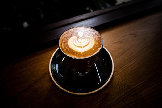 A cup of coffee latte top view with Microfoam milk leaf shape foam.