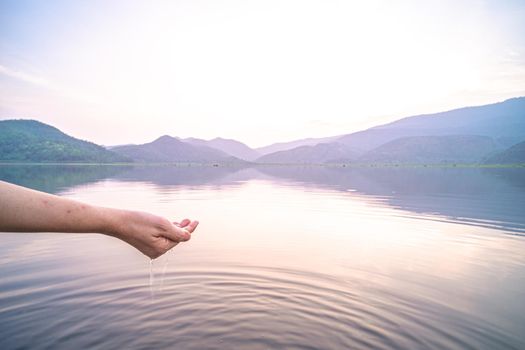 Woman taking clear water by hands