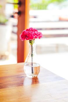 A bouquet of spring flowers in a vase, in a glass bottle