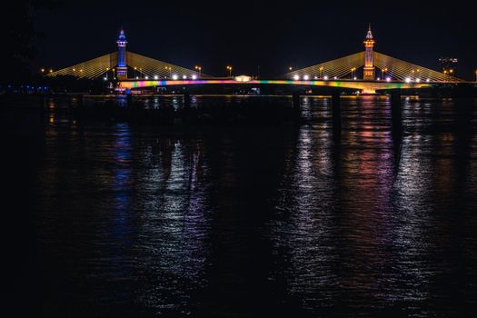 Suspension Bridge across river Lighting Colorful and Bewitching Effects. Chesadabodin Bridge, night scenes landscape.
