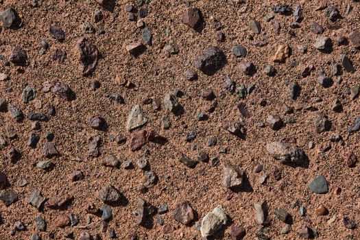 Black Gobi. Stony desert, black stones on the sand. Abstract natural background.