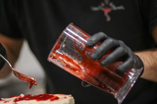 Bleeding monster cake with knife on cake stand