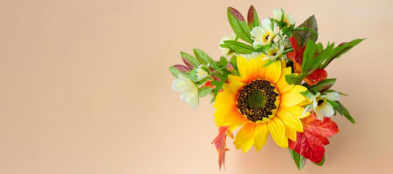 banner with fall bouquet on light background with place for text. sunflower and autumn leaves. copy space