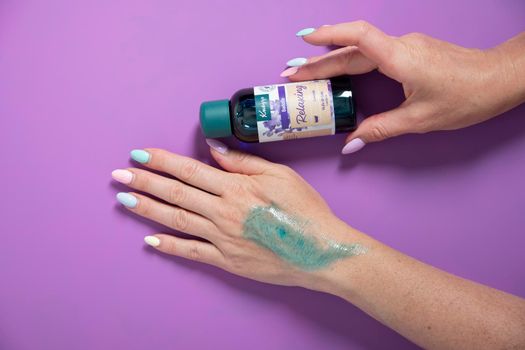 collage with Kneipp cosmetics Lavender soothing relaxing effect,woman testing bath oil on her hand, As,Belgium, June 30,2022. High quality photo