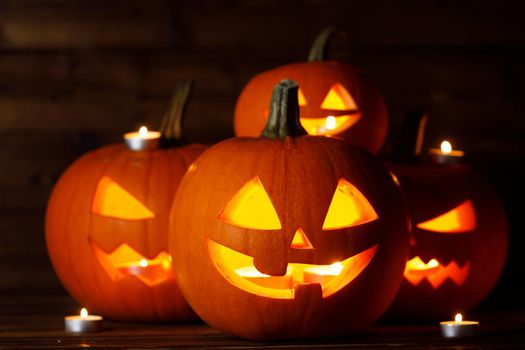 Halloween Jack O Lantern pumpkins and burning candles traditional decoration