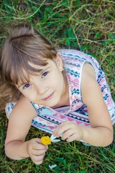 Girl with chamomile. Selective focus. nature flowers. Child.