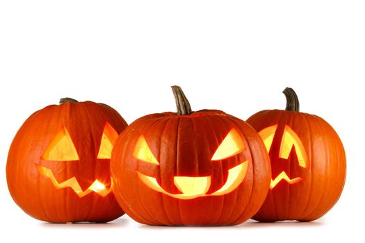 Three Halloween glowing lantern pumpkins in a row isolated on white background