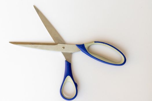 Metal scissors open on isolated white background