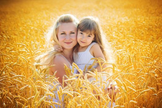 mother and daughter in a wheat field. selective focus. Nature.