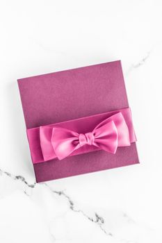 Birthday, wedding and girly branding concept - Pink gift box with silk bow on marble background, girl baby shower present and glamour fashion gift for luxury beauty brand, holiday flatlay art design