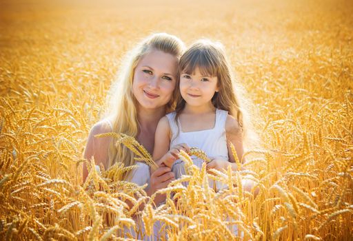 mother and daughter in a wheat field. selective focus. Nature.