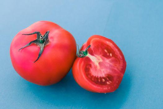 Plant based diet, vegetarian recipe and farm garden concept - Fresh ripe red tomatoes on blue background, organic vegetable food