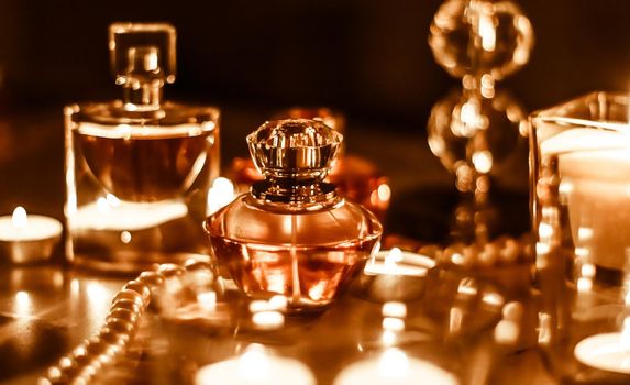 Perfumery, cosmetics branding and luxe concept - Perfume bottle and vintage fragrance on glamour vanity table at night, pearls jewellery and eau de parfum as holiday gift, luxury beauty brand present