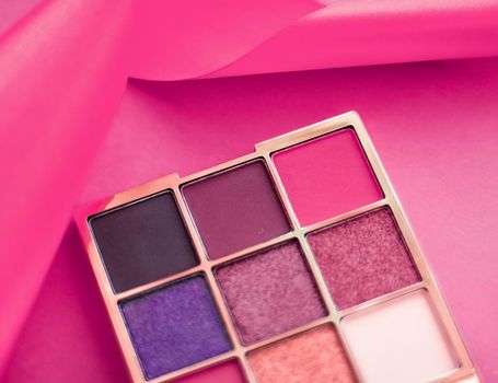 Cosmetic branding, mua and girly concept - Eyeshadow palette and make-up brush on pink background, eye shadows cosmetics product as luxury beauty brand promotion and holiday fashion blog design