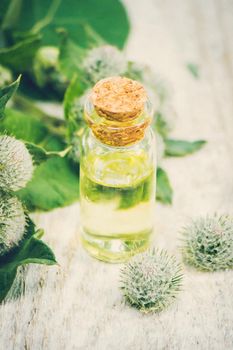 Tincture of burdock in a small jar. Selective focus. nature.