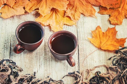 A cup of tea and a cozy autumn background. Selective focus. food.