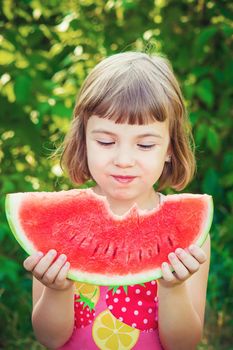 A child eats watermelon. Selective focus. Food nature.