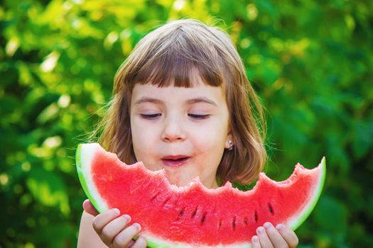 A child eats watermelon. Selective focus. Food nature.