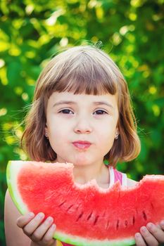 A child eats watermelon. Selective focus. Food nature.
