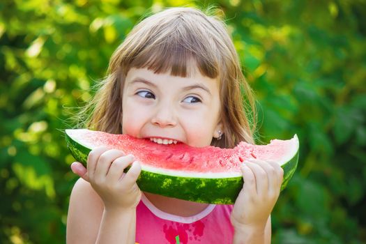 A child eats watermelon. Selective focus. Food nature.