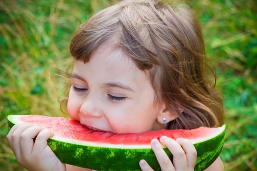 A child eats watermelon. Selective focus. Food nature.