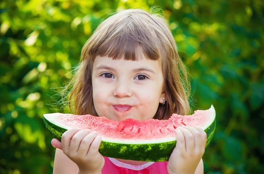 A child eats watermelon. Selective focus. Food nature.