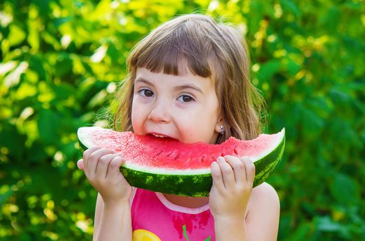 A child eats watermelon. Selective focus. Food nature.