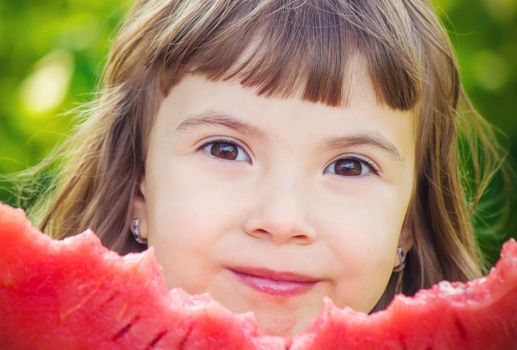 A child eats watermelon. Selective focus. Food nature.