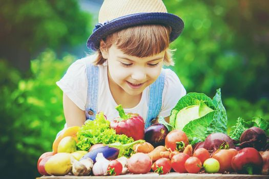 Child and vegetables on the farm. Selective focus. nature.