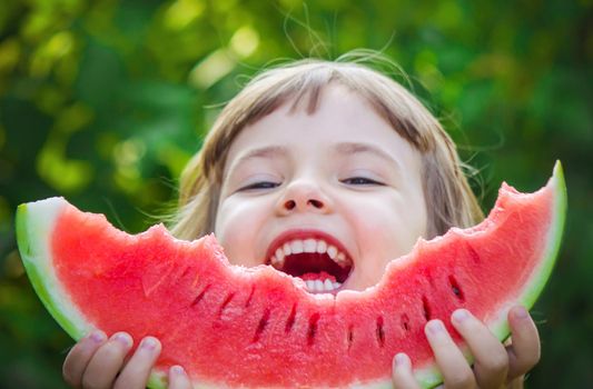 A child eats watermelon. Selective focus. Food nature.