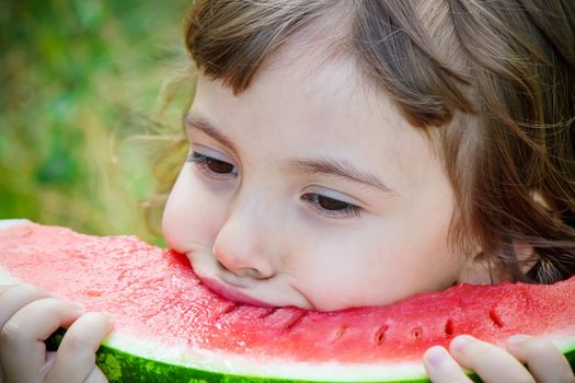 A child eats watermelon. Selective focus. Food nature.