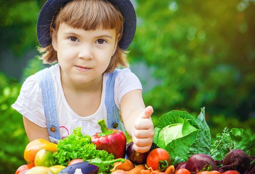 Child and vegetables on the farm. Selective focus. nature.