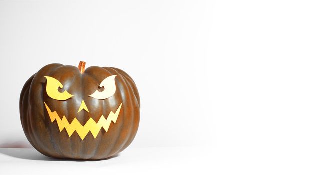 Halloween Pumpkin with Paper Cut Scary Face on a White Background. Jack Halloween. Smile Jack Pumpkin. Copy space