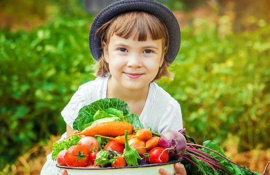 Child and vegetables on the farm. Selective focus. nature.