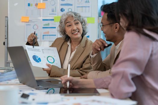 Group of Business people discuss a marketing strategy to improve the quality of their sales in the future at meeting room.