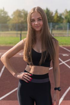 Young woman athlete runnner at the stadium outdoors