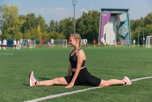 Young woman athlete runnner is exercising at the stadium outdoors