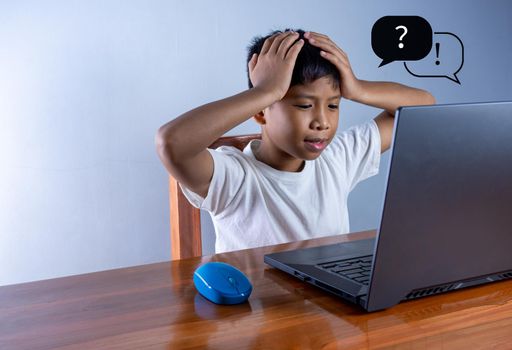 Education concept image. Creative idea and innovation. the boy sat staring at the computer and touched his temple. represents the inability to think