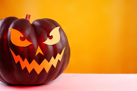 Halloween Pumpkin with Paper Cut Scary Face on a White Background. Jack Halloween. Smile Jack Pumpkin. Copy space