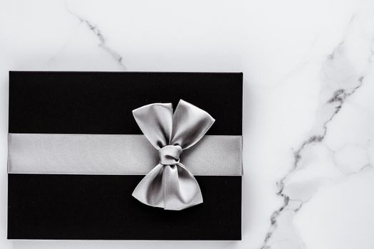 Present for him, shop sale promotion and anniversary celebration concept - Luxury holiday gifts with silver silk ribbon and bow on marble background