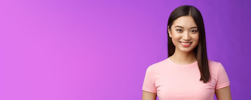Close-up motivated assertive good-looking asian woman smiling toothy white perfect grin, stand casually have pleasant conversation, talking upbeat, have exciting positive mood purple background.