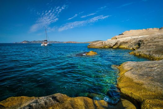 Yacht boat in Aegean sea at white rocks of Sarakiniko Beach, Milos island , Greece
