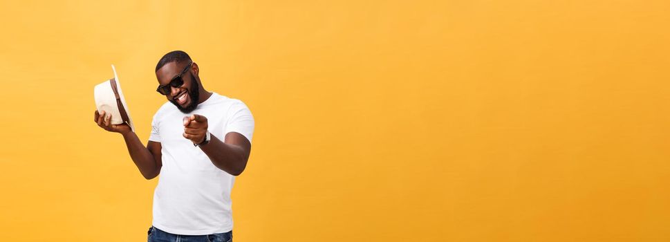 Young black man top dancing isolated on a yellow background