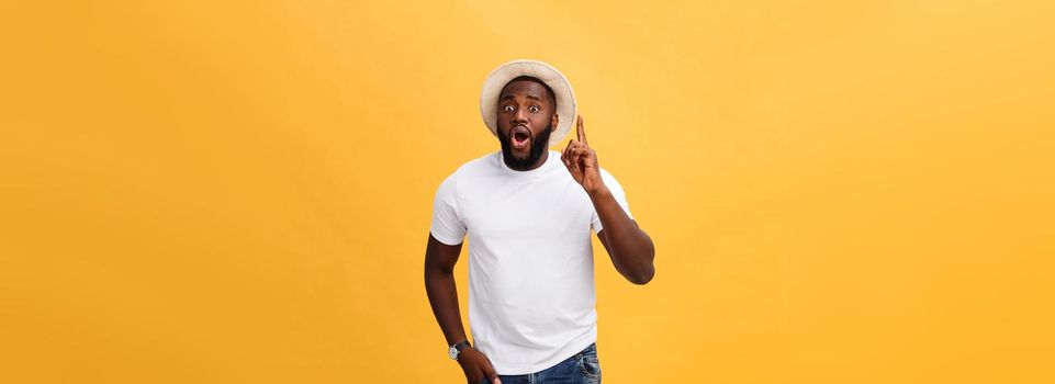 Human face expressions, emotions and feelings. Handsome young African American man looking up with thoughtful and skeptical expression, holding finger on his chin, trying to remember something